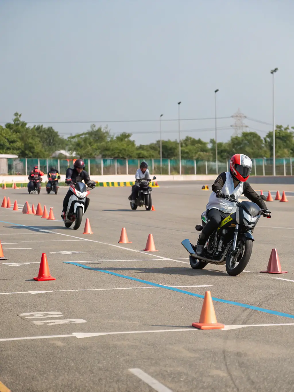A high-quality photo of a TEAM ALPIN RIDERS training session, focusing on beginner riders learning basic motorcycle handling skills in a controlled environment.